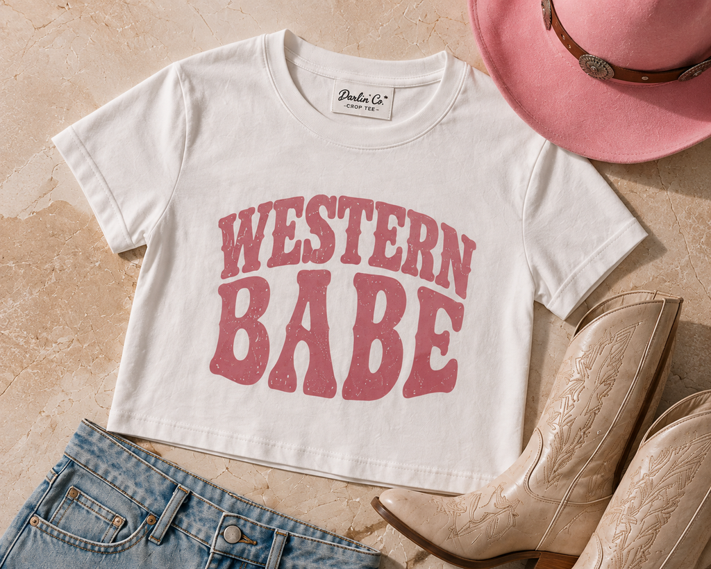 White Western Babe crop tee styled with pink cowboy hat, boots and denim