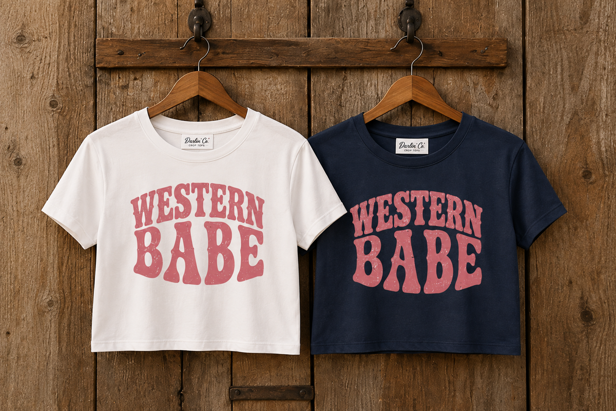 White and navy Western Babe crop tees displayed on hangers