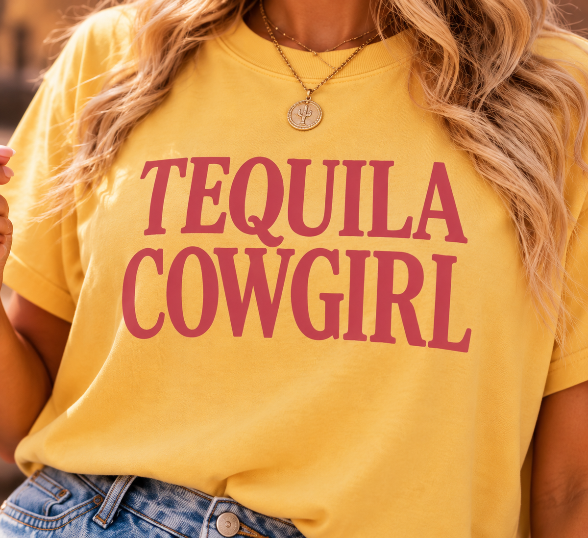 Close-up of the Tequila Cowgirl boxy tee showing the pink Western graphic