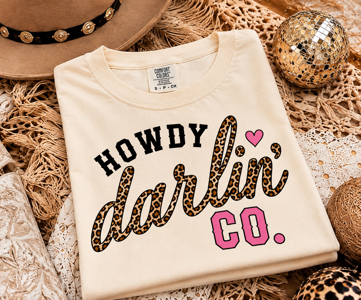Howdy Darlin’ Vintage White crop tee laid flat showing black, leopard and hot pink graphic