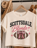 Scottsdale Blonde crop tee displayed on a wooden hanger