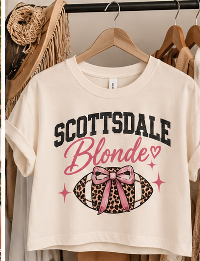 Scottsdale Blonde crop tee displayed on a wooden hanger