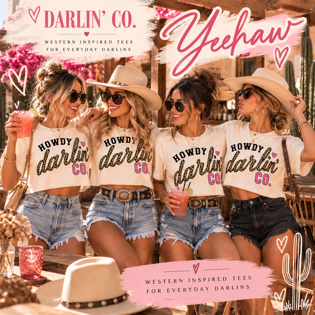 Four women in a rustic outdoor setting wearing matching white graphic tees that read 'HOWDY darlin' CO.' in black glitter-style lettering with a pink heart.