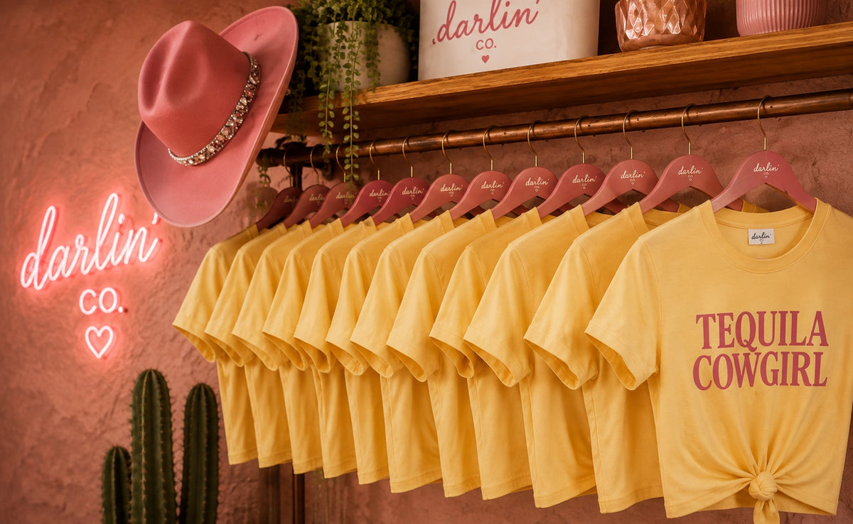 Tequila Cowgirl boxy tees displayed on hangers