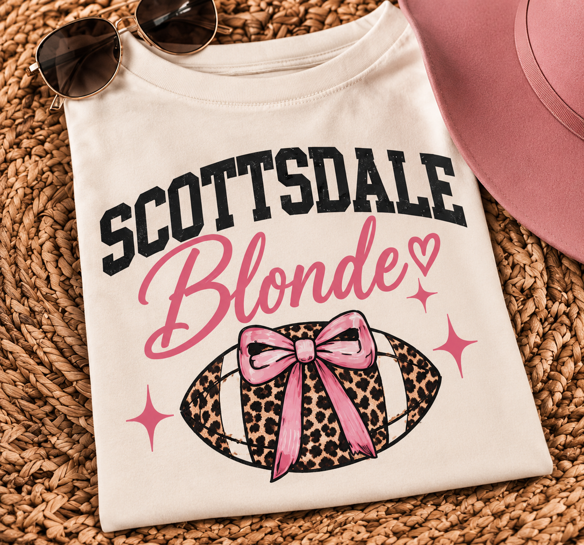 Close-up of the Scottsdale Blonde graphic with pink lettering and leopard football design