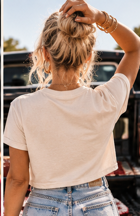 Back view of woman wearing the Sundays Are for Football crop tee with denim shorts