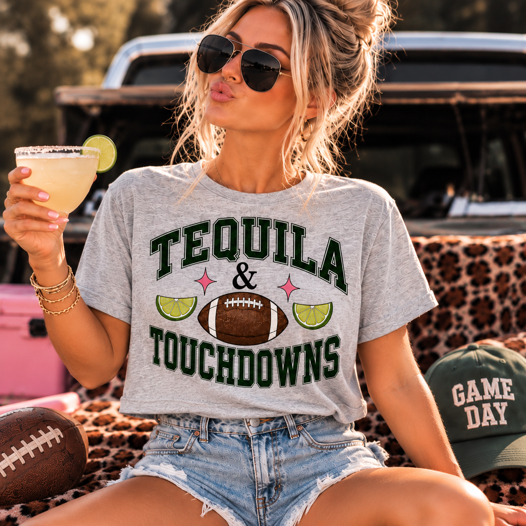 Woman wearing the Tequila & Touchdowns crop tee styled with denim shorts for game day