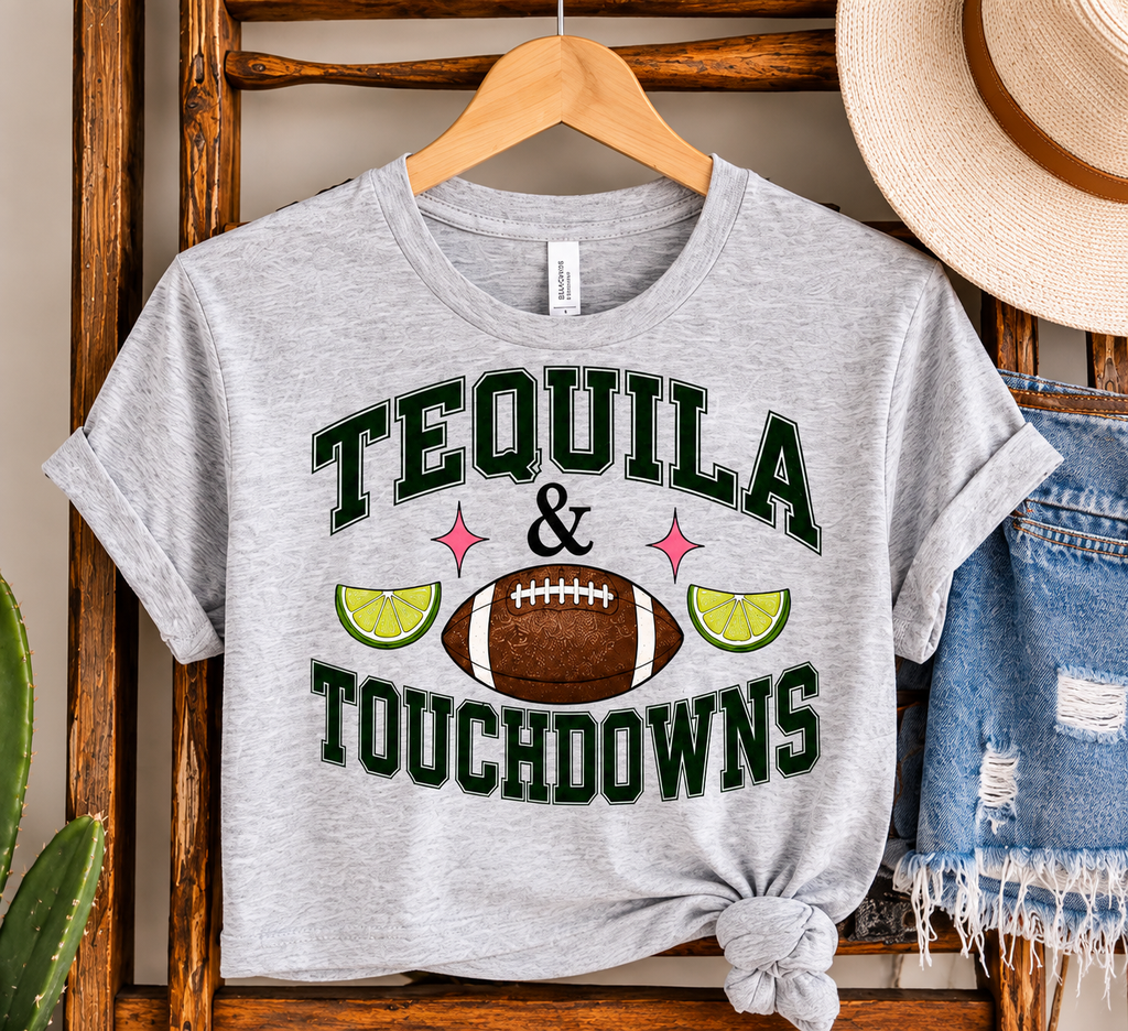 Tequila & Touchdowns crop tee displayed on a wooden hanger